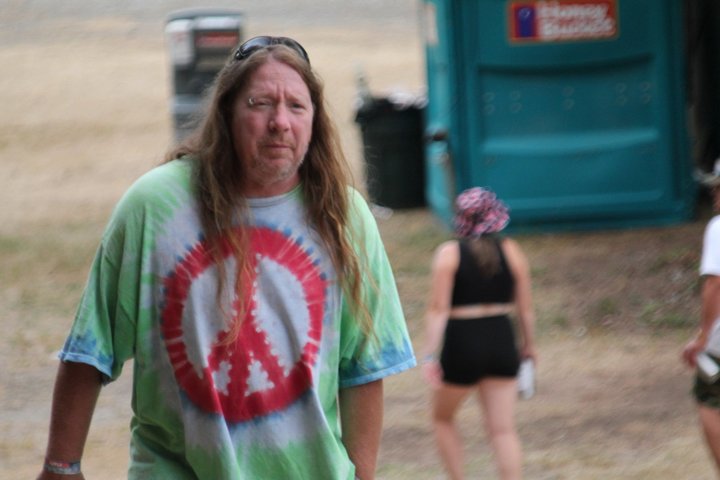 Festival attendee wearing a colorful tie-dye shirt