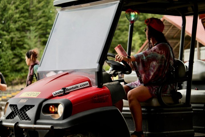 Festival attendee driving a small utility vehicle