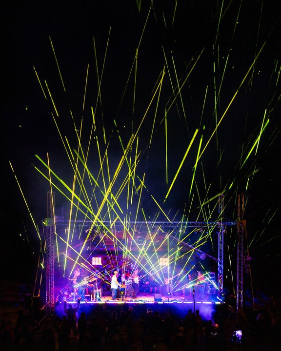 Laser beams lighting up the festival stage at night