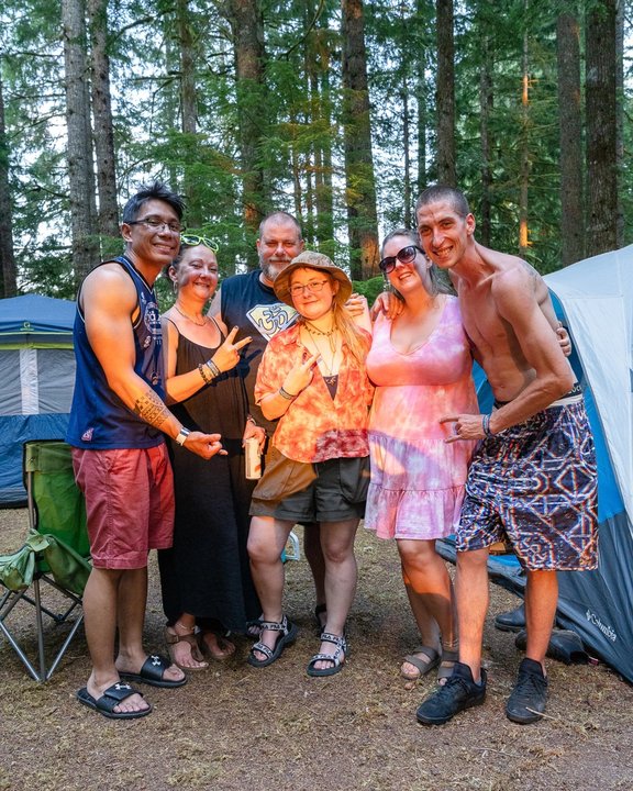 A group of friends posing together beneath the trees