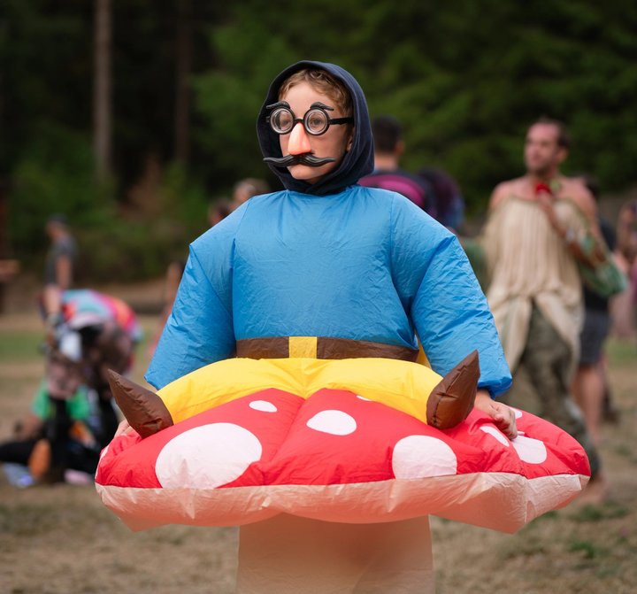 Festival attendee walking with a colorful inflatable ring