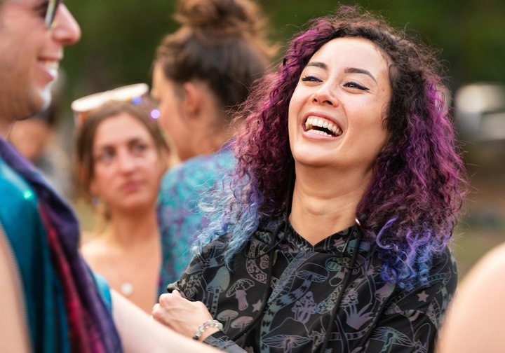 Festival attendee laughing among friends